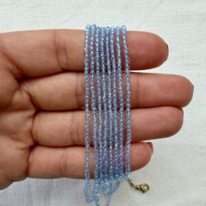 Alternative view of Collana in acciaio dorato con cristallo azzurro trasparente