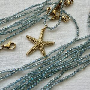 Collana in acciaio dorato con cristallo trasparente iridato